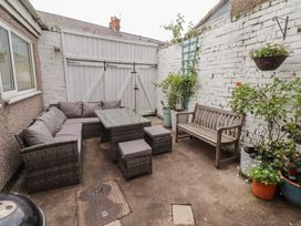 An outdoor patio area with seating and plants at Number Seventeen Amble