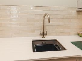 A kitchen sink with faucet and countertop at Cuddy's Holm in Seahouses