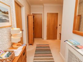 A hallway with doors and a lamp at Cuddy's Holm in Seahouses