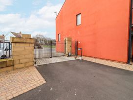 An outdoor area with a gate and pavement at Cuddy's Holm Seahouses