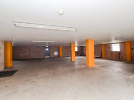 A garage with parking spaces and columns at Cuddy's Holm in Seahouses