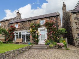 A house with flowers in the garden at Coble Cottage in Craster