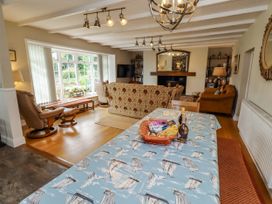 A living room with a table and sofa at Coble Cottage in Craster