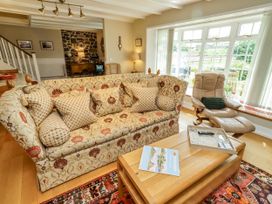 A living room with a sofa and coffee table at Coble Cottage in Craster