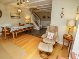 A dining room with a table and chairs at Coble Cottage Craster