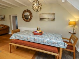 A dining room with a table and chairs at Coble Cottage in Craster