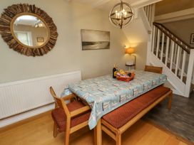 A dining room with a table and chairs at Coble Cottage in Craster