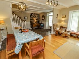 A dining room with a table and chairs at Coble Cottage Craster