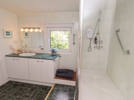 A bathroom with a shower and sink at Coble Cottage in Craster