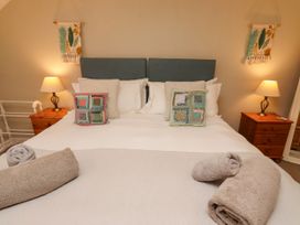 A bedroom with a bed and bedside table at Coble Cottage Craster