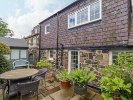 A garden with outdoor furniture and plants at Coble Cottage Craster
