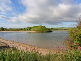 A landscape with water and an island at Percy Cottages No4 Alnmouth
