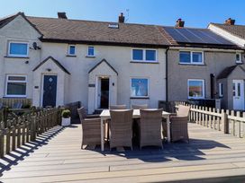 An outdoor seating area with table and chairs at Dunford Cottage in Bamburgh