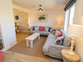A living room with a sofa and coffee table at Dunford Cottage in Bamburgh