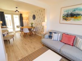 A living room with a sofa and dining area at Dunford Cottage in Bamburgh