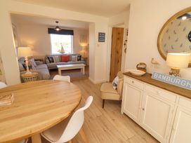 A dining room with a table and chairs at Dunford Cottage Bamburgh