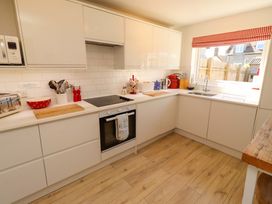 A kitchen with stove and sink at Dunford Cottage in Bamburgh