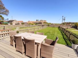 A garden with a table and chairs at Dunford Cottage Bamburgh