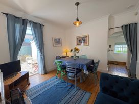 A dining room with a table and chairs at Anchor Cottage (Seahouses)
