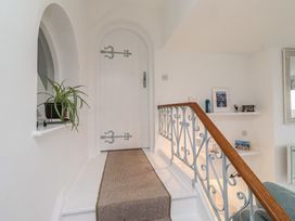 A staircase leading to a door in a hallway at Dell Point Beadnell