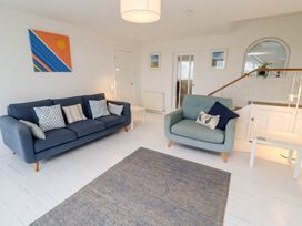 A living room with sofas and art on the wall at Dell Point in Beadnell