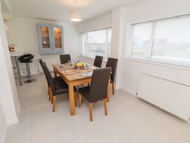 A dining room with a table and chairs at Dell Point in Beadnell