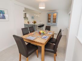 A dining room with a wooden table and chairs at Dell Point in Beadnell
