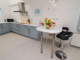 A kitchen with a bar table and chairs at Dell Point Beadnell