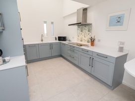 A kitchen with cabinets and a sink at Dell Point in Beadnell