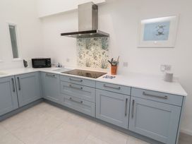 A kitchen with appliances and cabinets at Dell Point Beadnell
