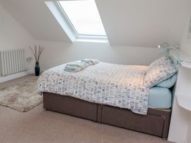 A bedroom with a bed and a window at Dell Point in Beadnell