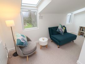 A snug with an armchair and a sofa at Dell Point in Beadnell