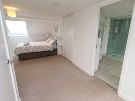 A bedroom with a bed and en-suite bathroom at Dell Point in Beadnell