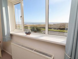 A living room window with a view of the sea at Dell Point in Beadnell