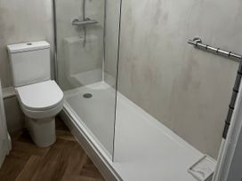A bathroom with a shower and toilet at Old Bakery No2 in Seahouses