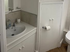 A bathroom with a sink and toilet at Old Bakery No2 Seahouses