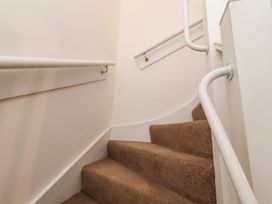 A staircase with a handrail at the Old Bakery No2 in Seahouses