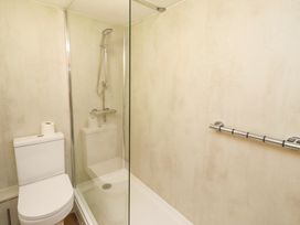 A bathroom with a shower and toilet at Old Bakery No2 in Seahouses