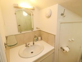 A bathroom with a sink and mirror at Old Bakery No2 Seahouses
