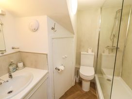 A bathroom with a sink, toilet, and shower at Old Bakery No2 in Seahouses