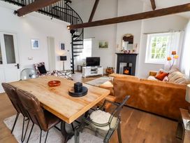 A living room with a dining table and a sofa at Treetops, Alnwick