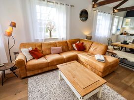 A living room with a sofa and coffee table at Treetops, Alnwick