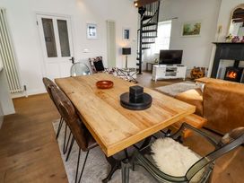A dining room with a wooden table and chairs at Treetops, Alnwick