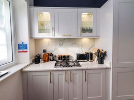 A kitchen with cabinets, countertop, stove, and various kitchen appliances at Treetops, Alnwick