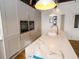 A kitchen with cabinets and an island at Treetops, Alnwick