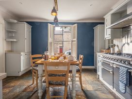A kitchen with a dining table set at Westhill House in Warkworth