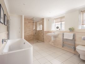 A bathroom with a bathtub and shower at Westhill House in Warkworth