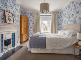 A bedroom with a bed and a chest of drawers at Westhill House Warkworth