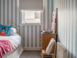 A bedroom with a bed, nightstand, and decorative artwork at Westhill House in Warkworth