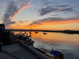 A view of boats on water during sunset at Westhill House in Warkworth